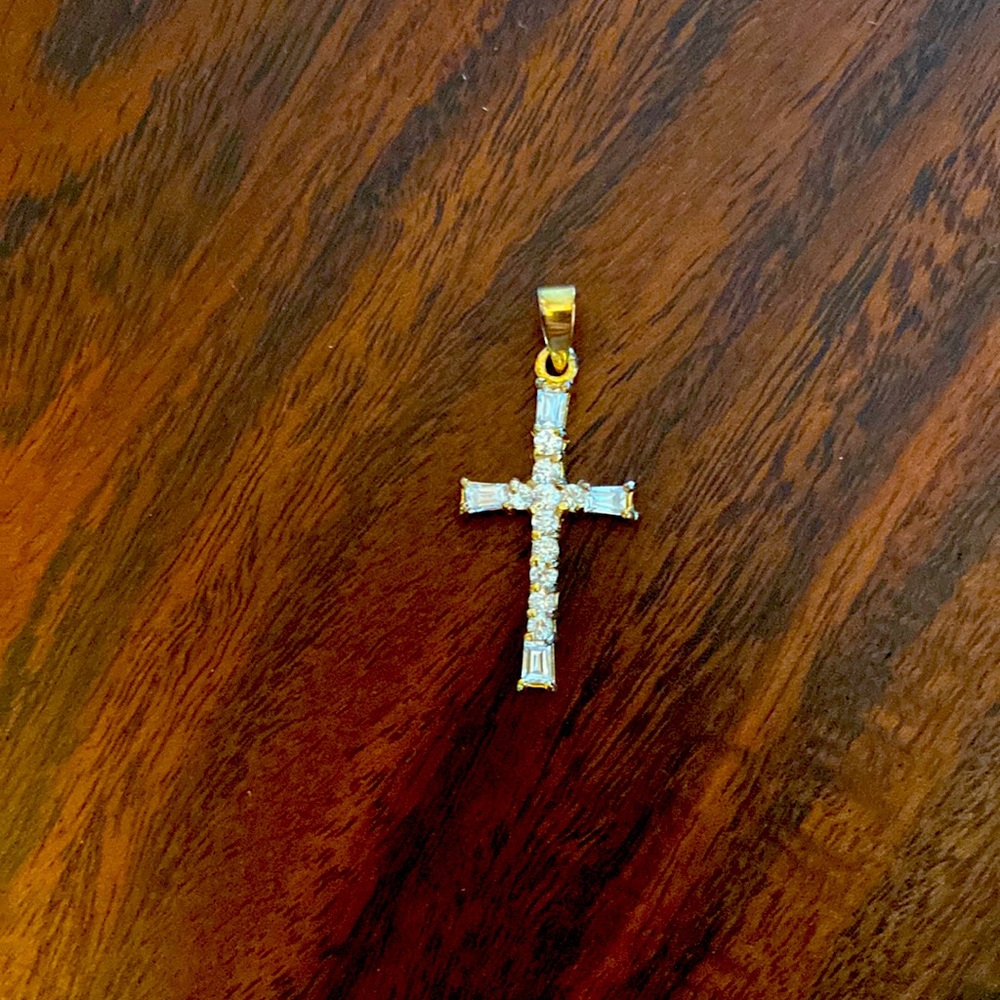 Gold tone CZ cross pendant.